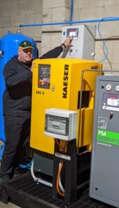 Damian McArdle standing beside Isolcell DCA equipment.