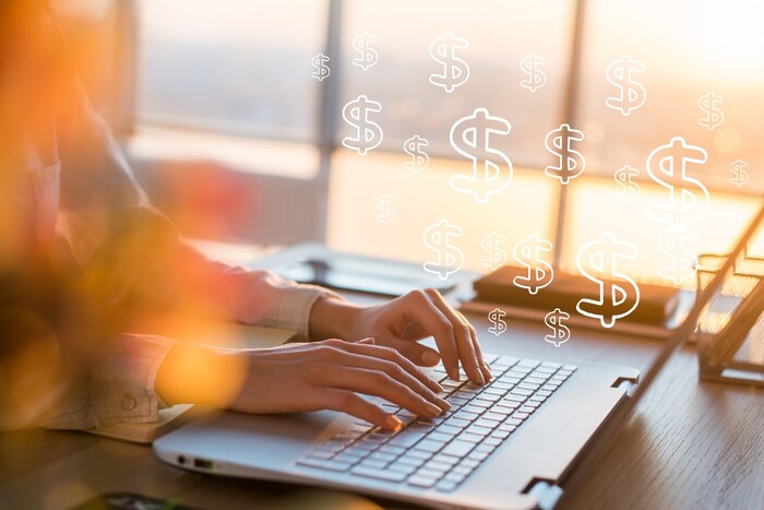 Woman typing on keyboard with $ signs rising from it.