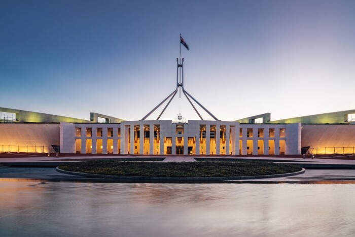 Parliament House across the lake at twilight.
