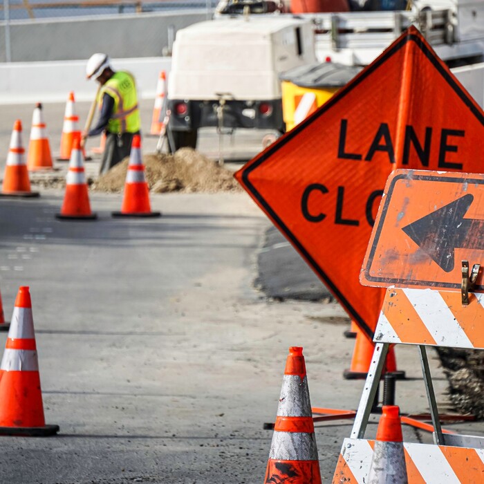 Roadworks with Lane Closed sign and orange/white cones
